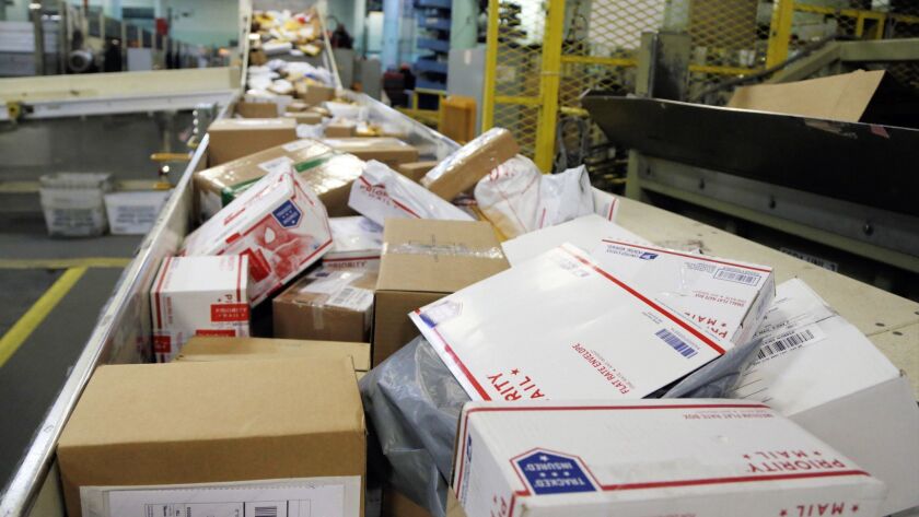 Packages travel on a conveyor belt for sorting at Omaha's main post office in November.
