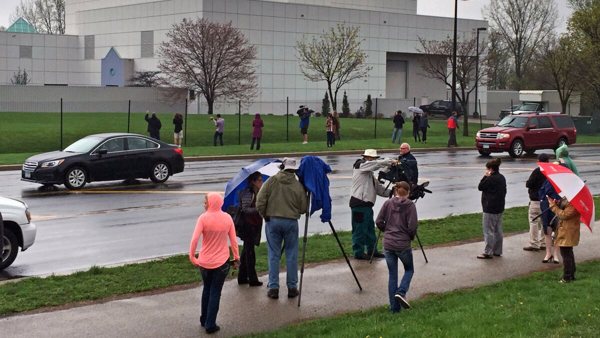 People stand outside entertainer Prince's Paisley Park compound in Chanhassen, Minn., in April 2016.