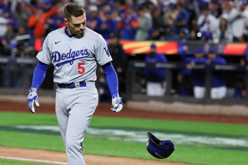 NEW YORK, NEW YORK - OCTOBER 18: Freddie Freeman #5 of the Los Angeles Dodgers tosses his helmet.