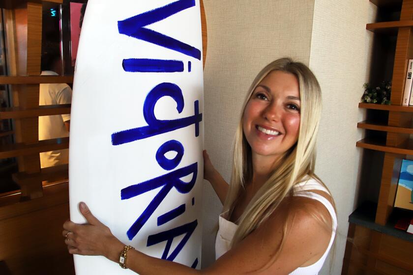 Victoria White, a Los Angeles- based artist is the featured artist for this year's U.S. Open of Surfing she poses with her signature surf board at Pasea Hotel & Spa in Huntington Beach on Friday, August 2, 2024. She will be live painting a new, iconic, triple-surfboard portrait of Surf Legend Andy Irons for her U.S. Open exhibition as a tribute to his contribution o surfing. She is committed to giving back after facing grave illness and then pivoting to become one of the most emerging artist today. (Photo by James Carbone)