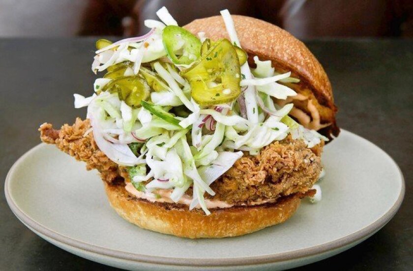The fried chicken sandwich with a spicy slaw and rooster aioli at Son of a Gun.