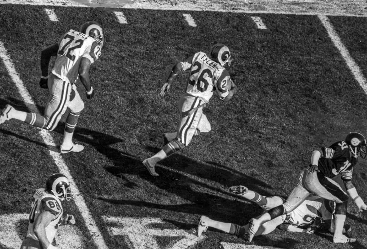 Jan. 20, 1980: L.A.'s Wendell Tyler (26), escorted by teammate Kent Hill (72), breaks loose for a 39-yard run in the first quarter to set up the Rams' first touchdown. Pittsburgh's Donnie Shell (31), harassed by Rams' Billy Waddy, gives chase.