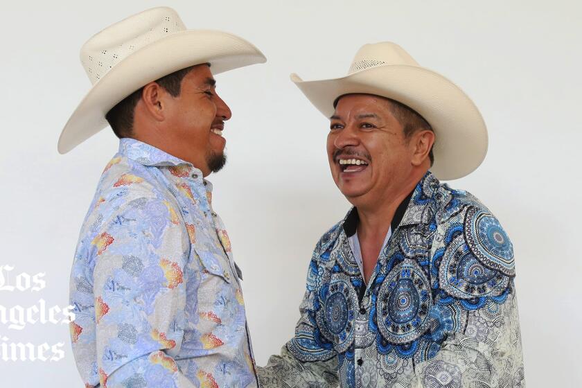 Ramiro Garcia and Daniel Renteria are smiling as they dance.