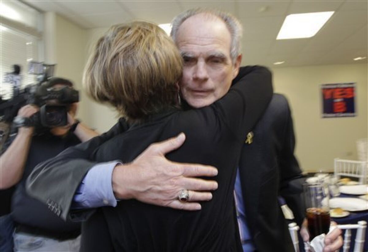 San Jose Mayor Chuck Reed, right, hugs former San Jose Vice Mayor Pat Dando at a campaign party in San Jose, Calif., Tuesday, June 5, 2012. As state and local governments across the country struggle with ballooning pension obligations, voters in two major California cities cast ballots Tuesday on sweeping measures to curb retirement benefits for government workers. Reed, a Democrat, joined an 8-3 City Council majority to put San Jose Measure B on pension reform on the ballot. (AP Photo/Paul Sakuma)