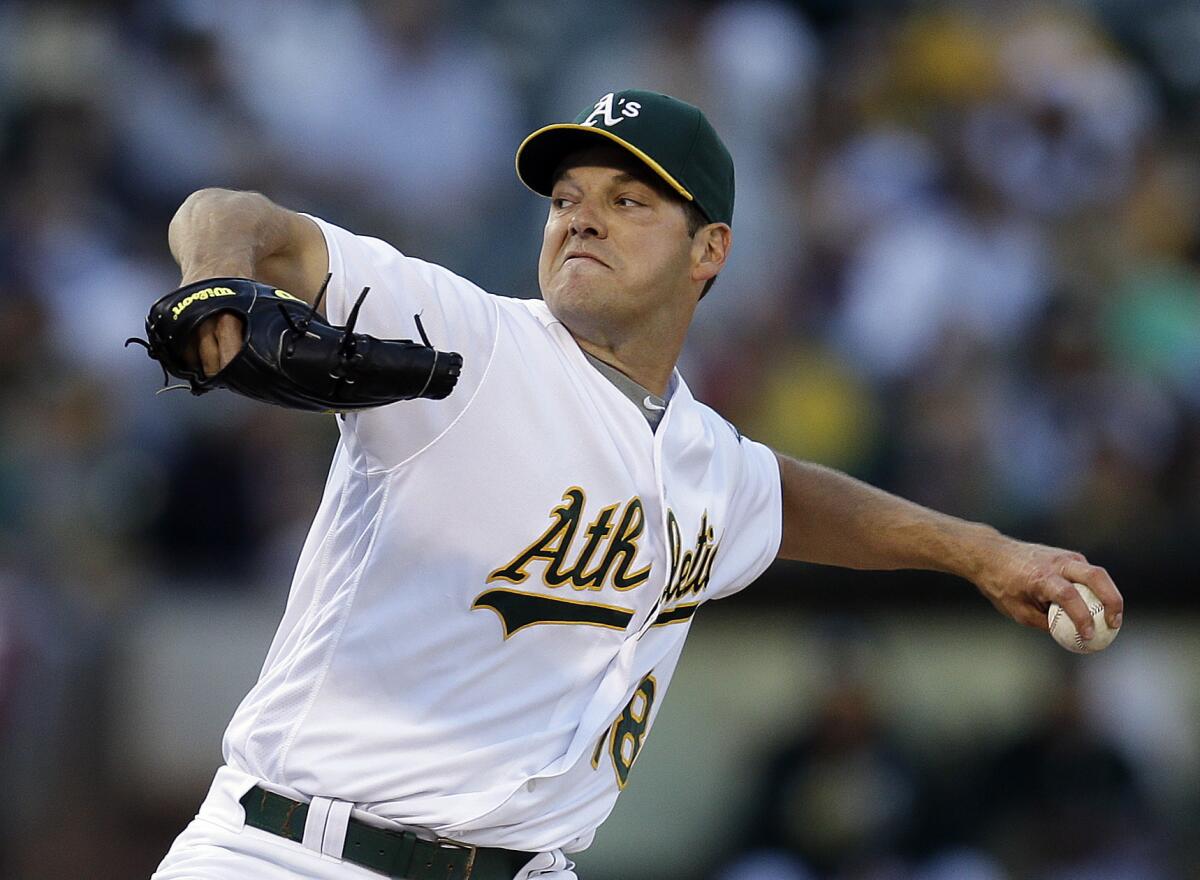 Rich Hill pitches for Oakland.