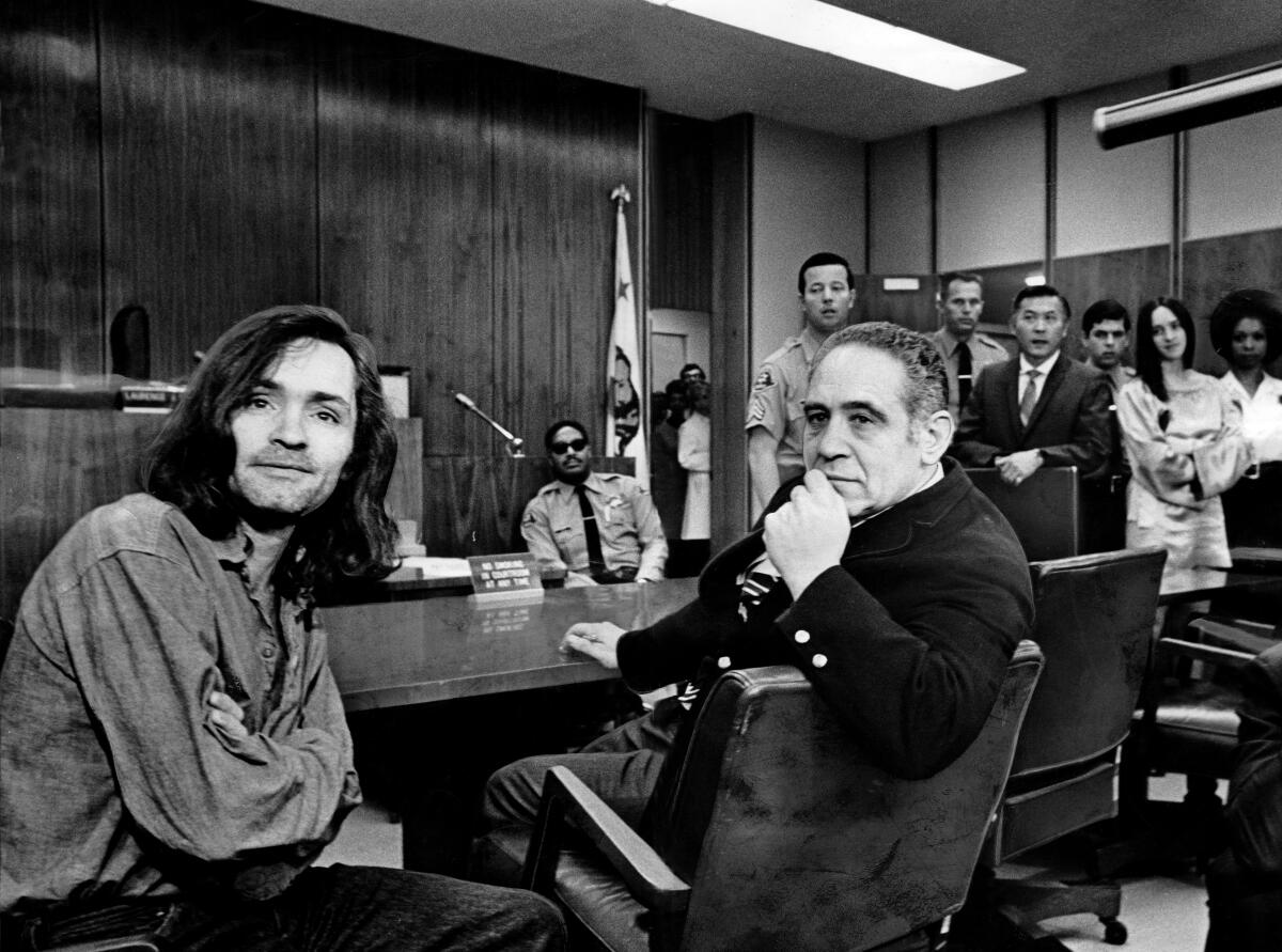 Charles Manson, left, sits in court with criminal defense attorney Irving Kanarek in 1970.