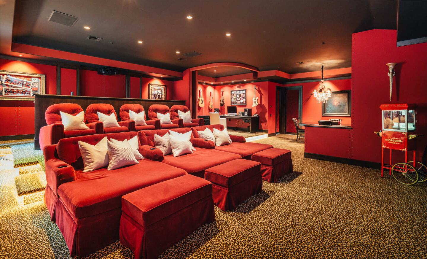 The custom home includes a library, billiards room and crimson-colored movie theater with cheetah-print carpet.