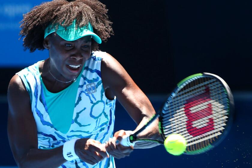 Venus Williams returns a shot against Camila Giorgi during their third-round match at the Australian Open on Saturday in Melbourne.