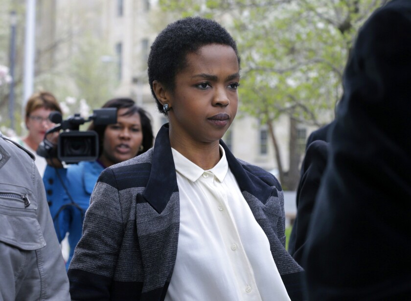 Lauryn Hill, shown in April outside a federal courthouse in Newark, N.J., has reported to prison to serve a three-month term for tax evasion.