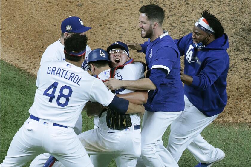 Arlington, Texas, Tuesday, October 27, 2020 Julio Urias is mobbed as the Dodgers win.