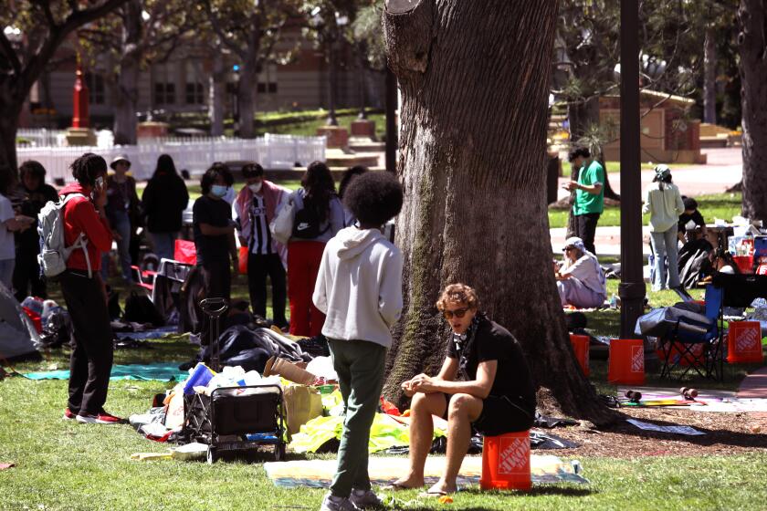 LOS ANGELES, CA - APRIL 27, 2024 - USC students, who protest the war in Gaza, spend time at the tent camp they erected at Founders Park on the USC campus in Los Angeles on April 27, 2024. The campus gates are closed to the public and the marquee 65,000-attendee "main stage" commencement ceremony has been called off. (Genaro Molina/Los Angeles Times)