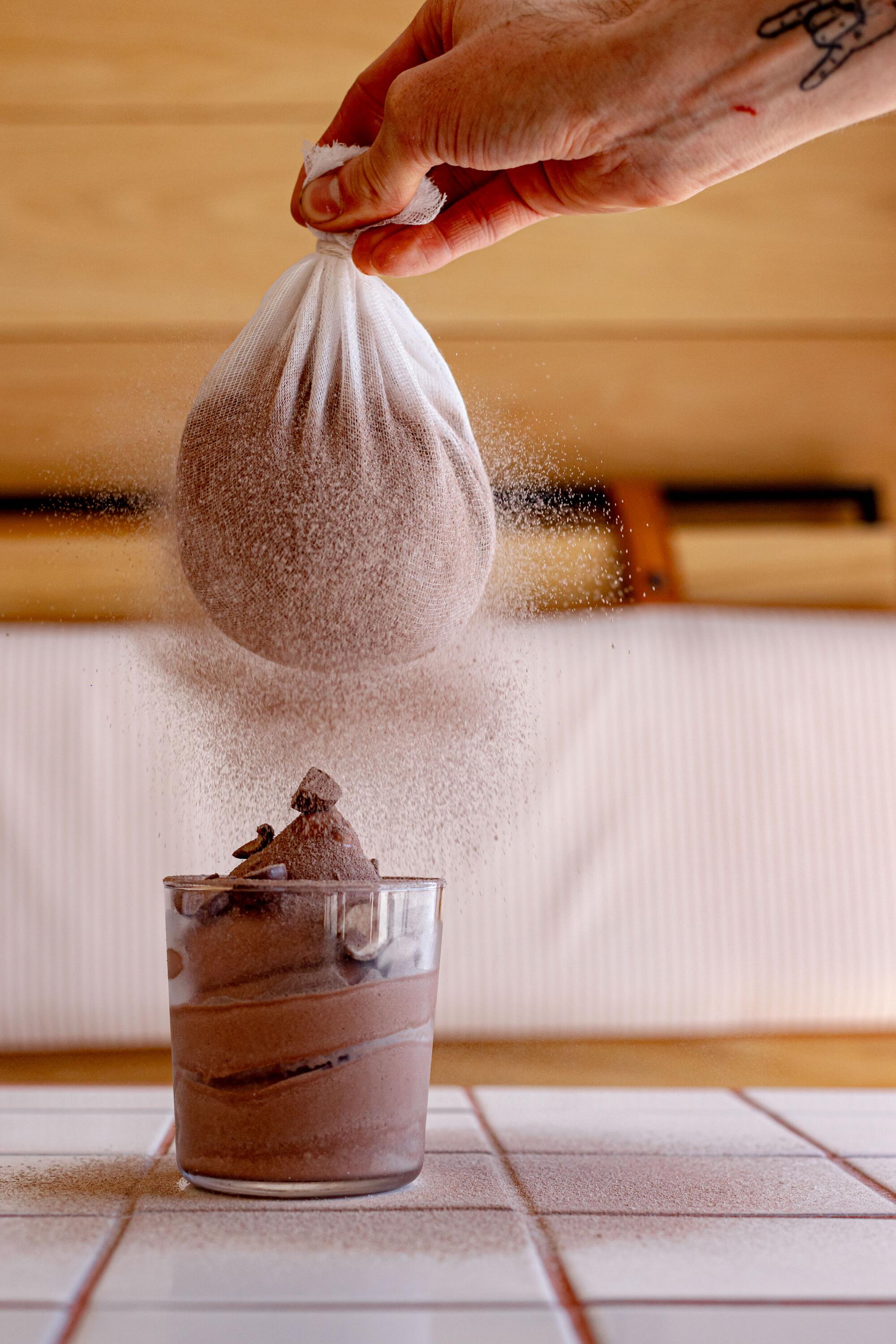 Chef Miles Shorey dusts malted chai soft serve with chocolate-chai powder.