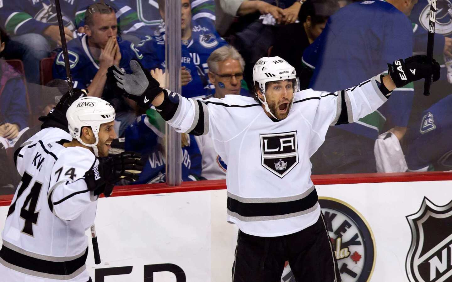 Kings center Jarret Stoll, right, celebrates alongside teammate Dwight King after scoring in overtime to lift the Kings to a 2-1 victory over the Vancouver Canucks in Game 5 of the Western Conference quarterfinals.