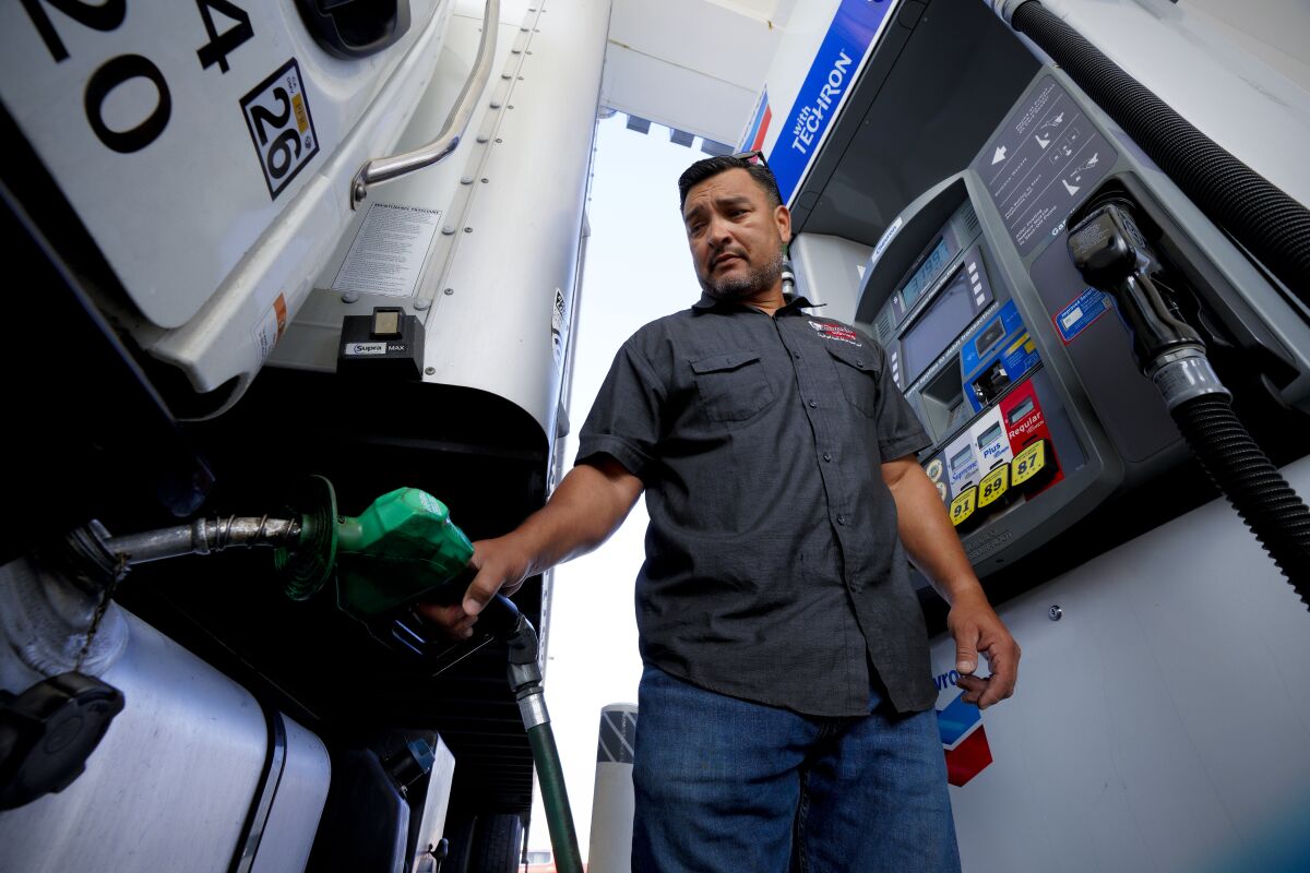 Arthur McCanless, owner of Elmer’s Moving, fills up his truck with diesel fuel.   