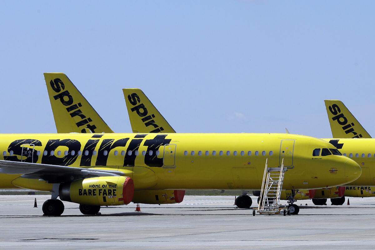 FLE - A line of Spirit Airlines jets sit on the tarmac at the Orlando International Airport on May 20, 2020, in Orlando, Fla. Spirit announced on Thursday, July 7, 2022, that it would again postpone a vote on the proposed merger with Frontier, a sign that it lacks shareholder support for the merger in the face of a rival bid by JetBlue Airways. Spirit delayed the vote by a week, until July 15. (AP Photo/Chris O'Meara, File)