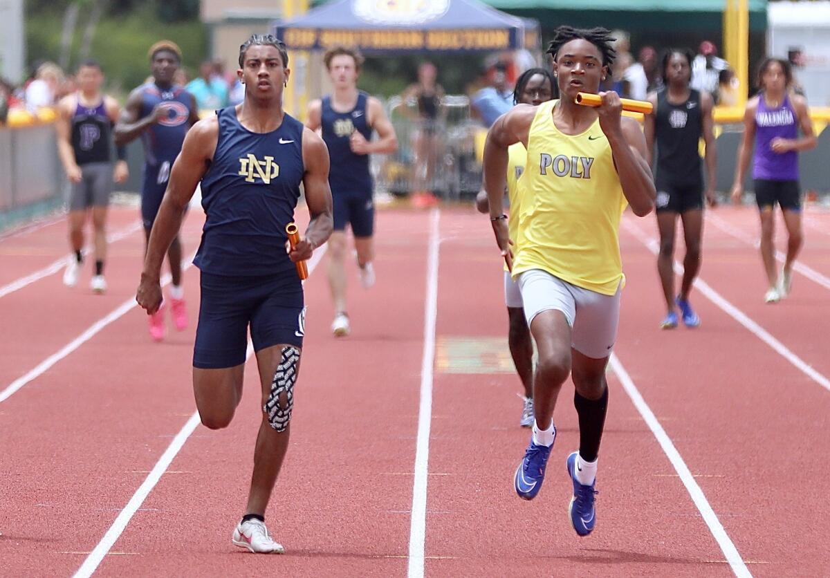 Notre Dame's Tre Fernandez, left, and Poly's Donte Wright Jr. sprint to the finish in the Masters Meet's 4x100 relay.