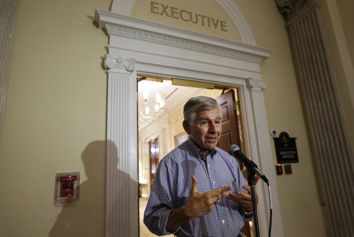Former Massachusetts Gov. Michael Dukakis speaks with reporters at the Statehouse in Boston on Sept. 9. He has a long-standing relationship with conservative Republican Rep. Jason Chaffetz of Utah.