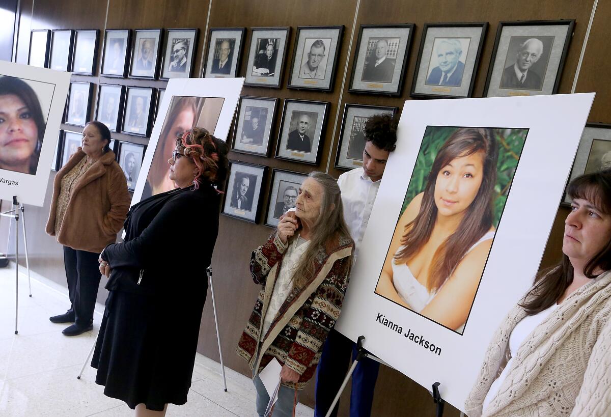 Family members gather around pictures of their loved ones after Franc Cano was sentenced to life in prison.