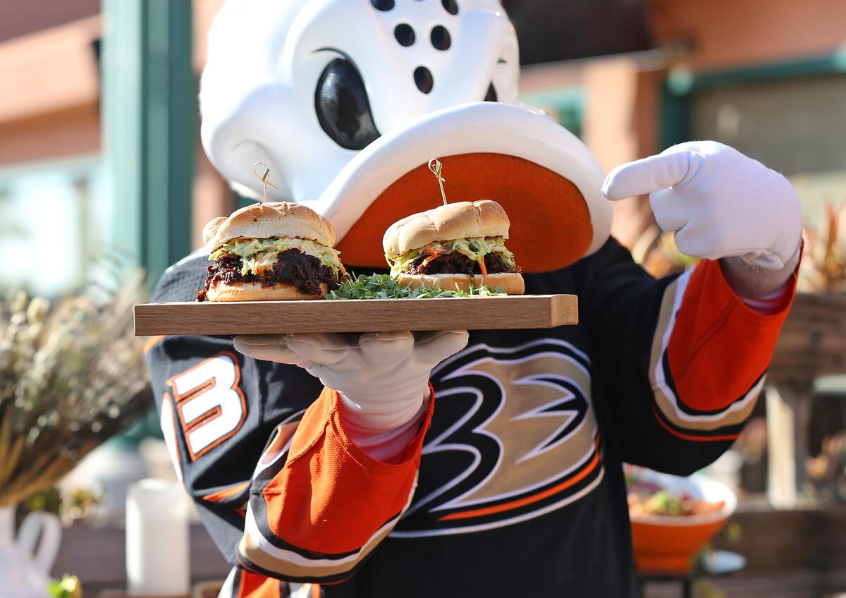 Wild Wing, the Anaheim Ducks mascot, shows off the new culinary offerings at the Honda Center.
