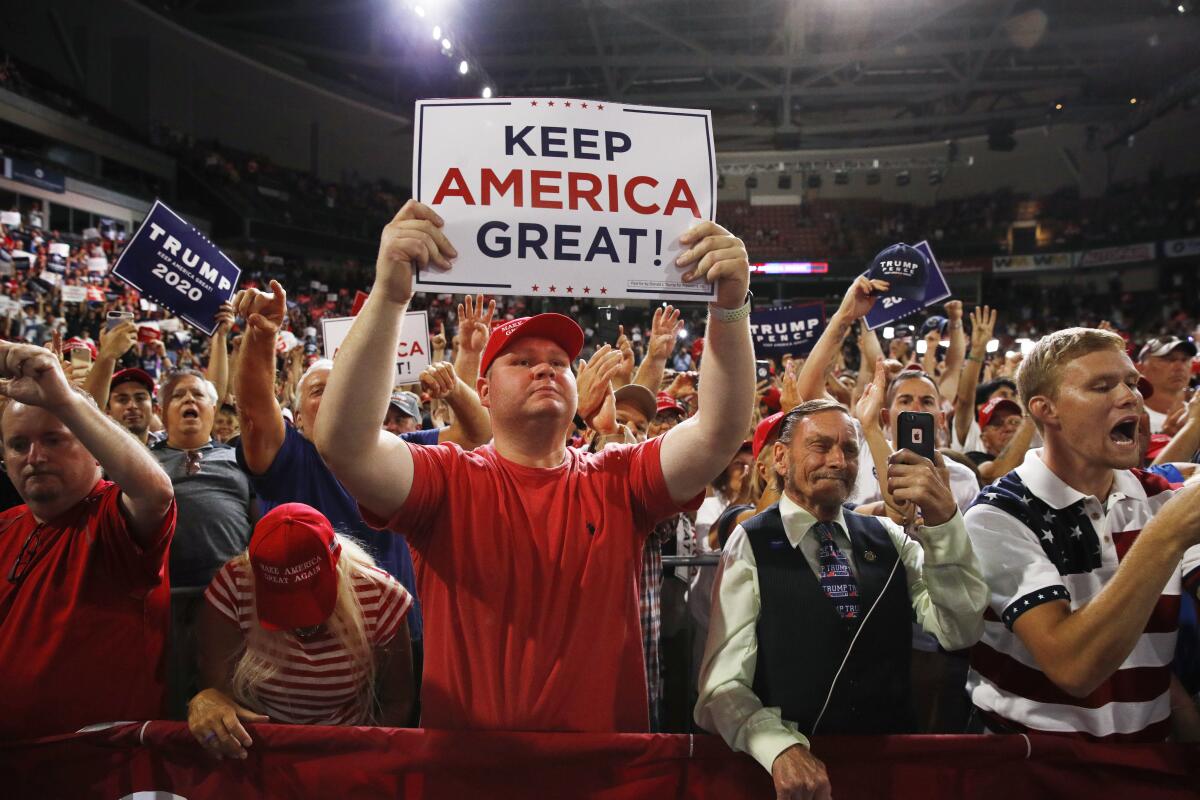 Supporters rally as President Trump speaks at a campaign rally Thursday in Manchester, N.H.