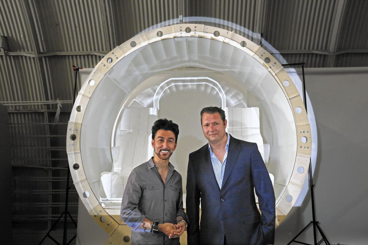 Bibop Gresta, Hyperloop Transportation Technologies' operations chief, left, and CEO Dirk Ahlborn in front of a model of a Hyperloop capsule.