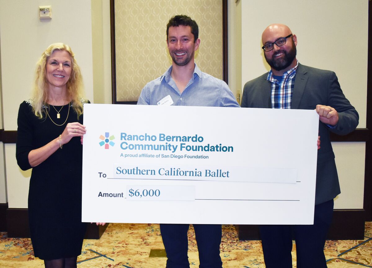 Toby Batley, center, accepted a $6,000 grant on behalf of Southern California Ballet. 