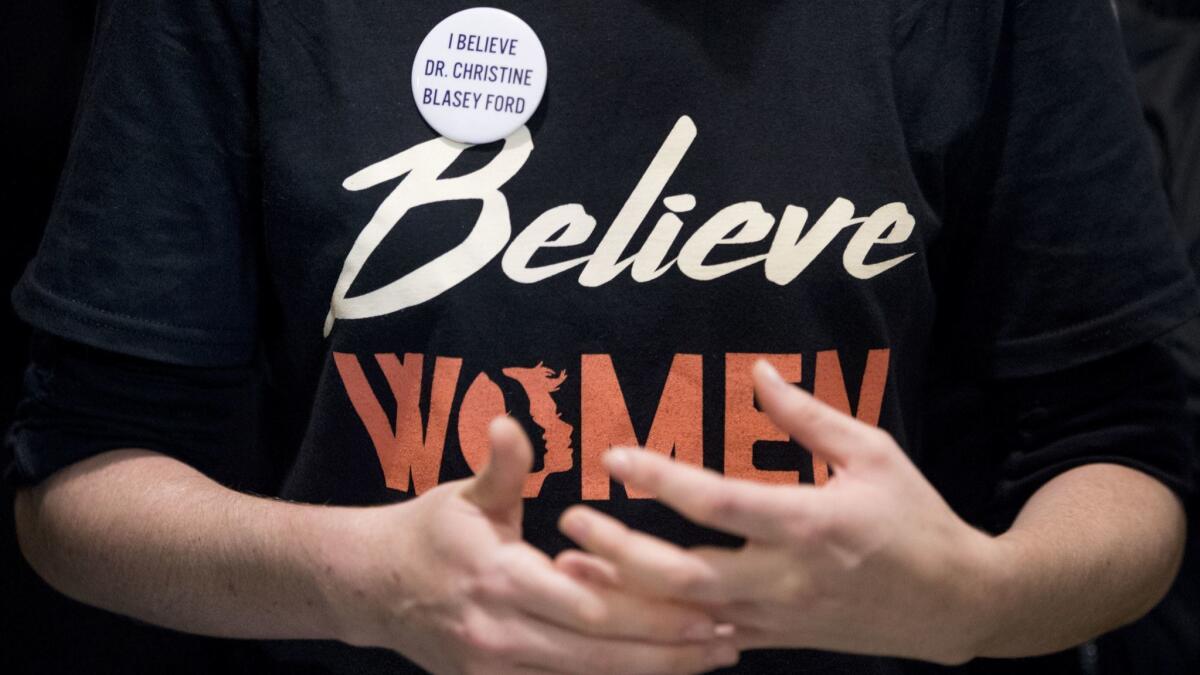 A woman wears a shirt that reads "Believe Women" with a button that reads "I Believe Dr. Christine Blasey Ford" in Washington, DC on Monday.