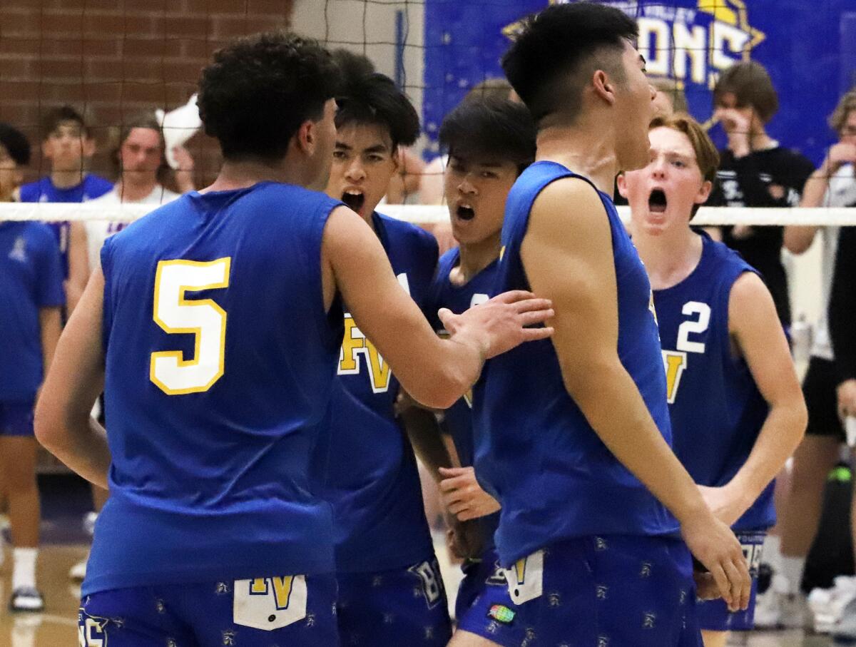 The Fountain Valley boys' volleyball team celebrates a point against Los Alamitos on Thursday.