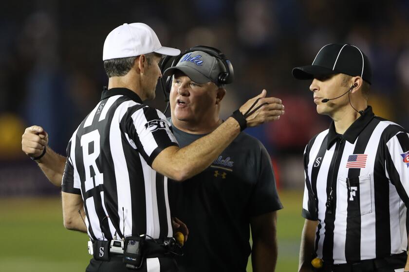 LOS ANGELES, CALIFORNIA - OCTOBER 26: Head coach Chip Kelly argues with Referee Chris Coyte, and Field Judge Steve Currie during the second half of a game against the Arizona State Sun Devils on October 26, 2019 in Los Angeles, California. (Photo by Sean M. Haffey/Getty Images)