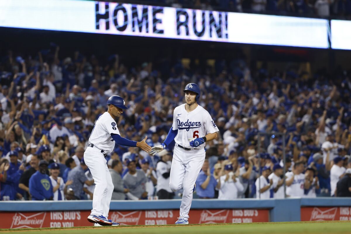 Trea Turner celebrates with Dodgers coach Dino Ebel after a solo home run in the third inning of Game 2 of the NLDS.