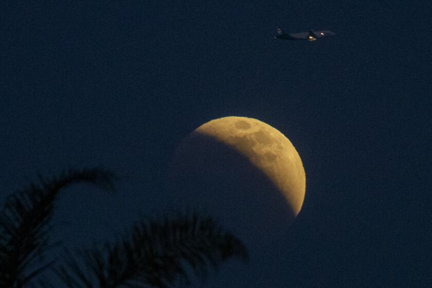 Huntington BEach, CA - May 15: The Super Flower Blood Moon lunar eclipse is viewed from , Huntington BEach, CA on Sunday, May 15, 2022. (Allen J. Schaben / Los Angeles Times) Sunday's full moon will be the first "super moon" of 2022, with three more set to occur this year. During the so-called "super moon," the moon appears larger and brighter in the sky than it does at other times. Each month's full moon has its own unique name, and in the month of May, the "flower moon" takes to the skies over Earth. According to Live Science, the sun's light rays are able to get around the Earth during an eclipse, but as they do so, they first go through the planet's atmosphere, scattering shorter-wavelength blue light from reaching the moon's surface. As a result, the moon appears red during a lunar eclipse.