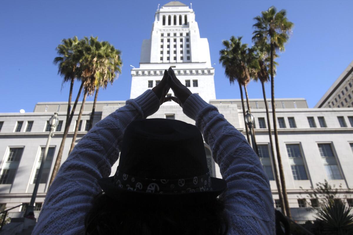 A community activist participates in a demonstration in front of L.A. City Hall over the lack of affordable housing.