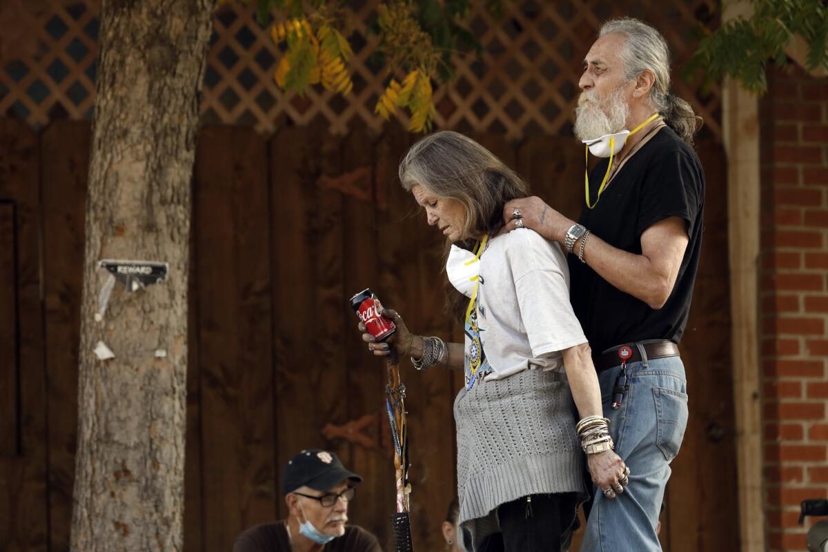 Kathy Bartley and her partner Gary, a Vietnam veteran, attend an emergency community meeting in the town of Oroville