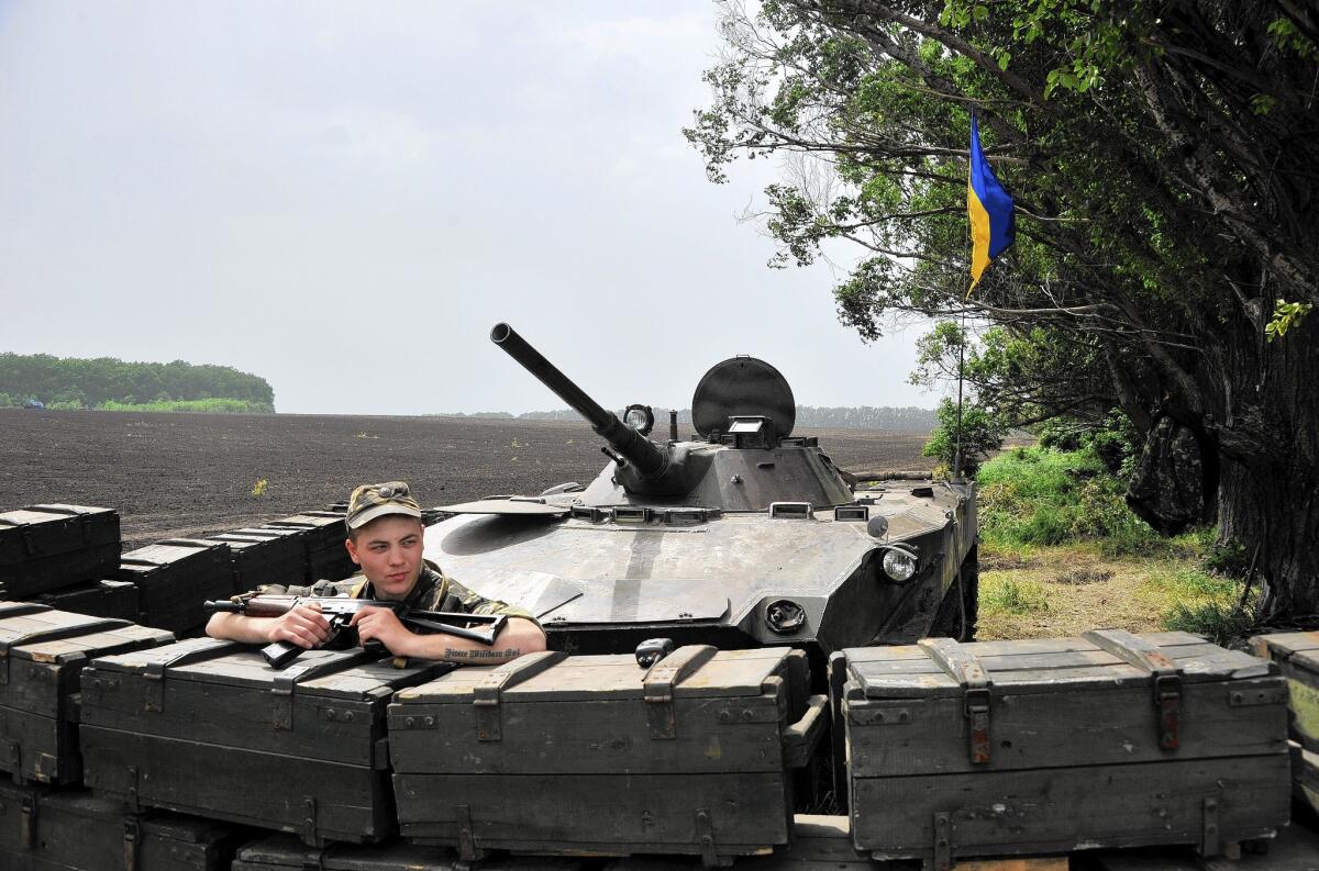 Ukrainian troops guard the road from Izyum to Slovyansk in eastern Ukraine.