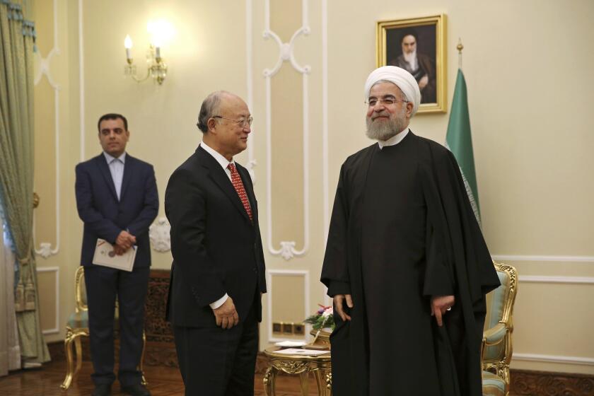 Iranian President Hassan Rouhani, right, welcomes U.N. nuclear agency chief Yukiya Amano to a meeting in Tehran on Sept. 20, 2015.