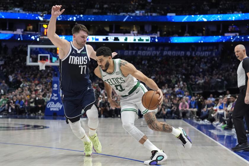 Boston Celtics forward Jayson Tatum (0) drives against Dallas Mavericks guard Luka Doncic (77) during the second half of an NBA basketball game in Dallas, Monday, Jan. 22, 2024. (AP Photo/LM Otero)