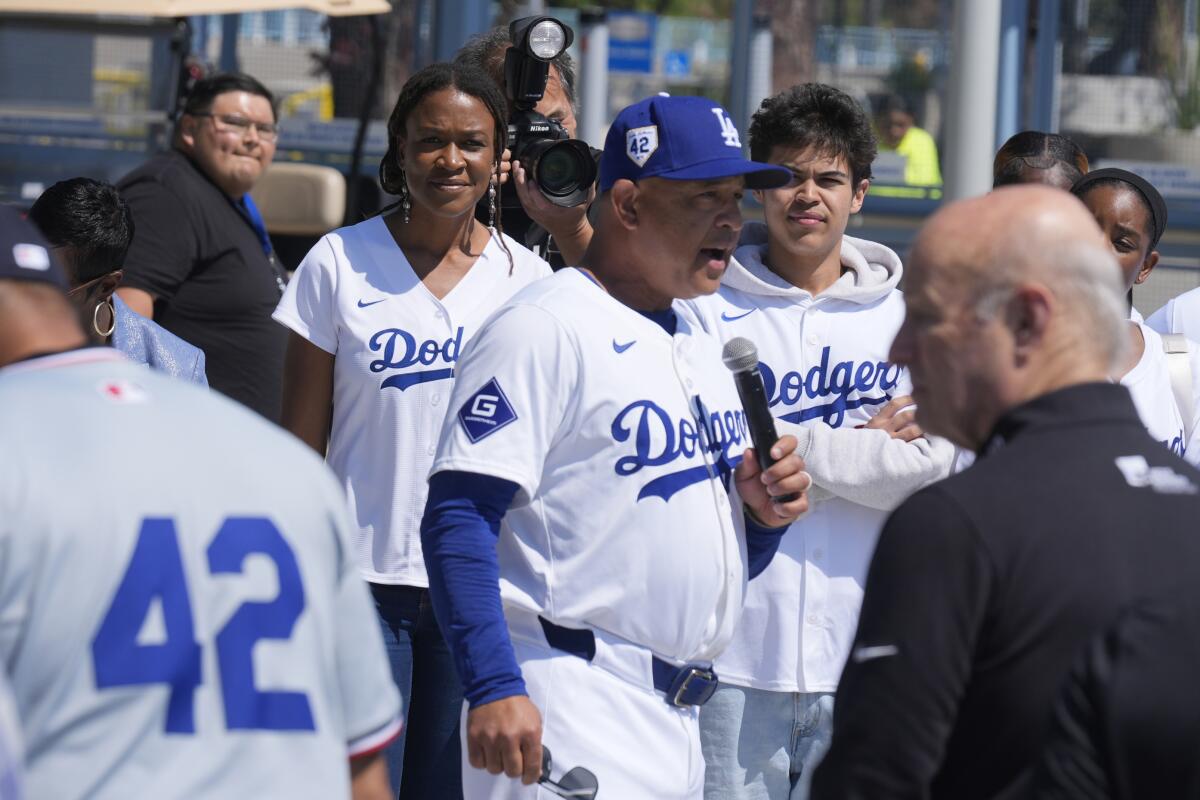 Dodgers manager Dave Roberts, center, introduces Ayo Robinson, the granddaughter of baseball legend Jackie Robinson.