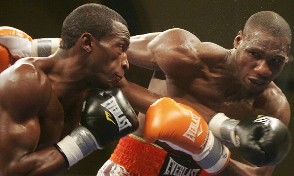 Cuban boxer Erislandy Lara, left, punches Paul Williams during their welterweight bout in Atlantic City, N.J., in 2011. Williams won by unanimous decision.