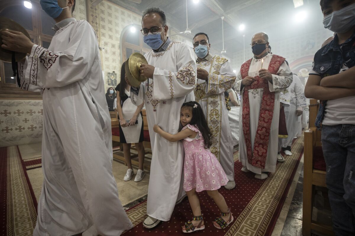 FILE - Coptic Orthodox deacon pray during Easter mass, at Holy Cross Church in Cairo, Egypt, Saturday, May 1, 2021. An Egyptian court Saturday, June 12, 2022, sentenced a man to die for the April stabbing death of a Coptic Christian priest in an attack that shocked the Arab World’s most populous nation. (AP Photo/Nariman El-Mofty, File)