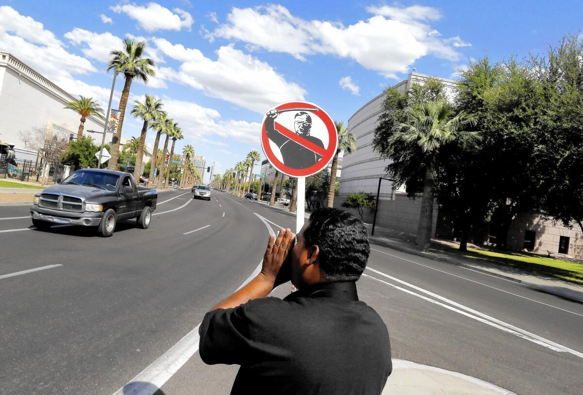 Hilario Alexander protests in Phoenix against crackdowns on people suspected of being in the U.S. illegally. Maricopa County, Ariz., Sheriff Joe Arpaio is accused of using racial profiling in such crackdowns in defiance of a court order.