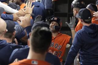 Houston Astros' Jose Altuve (27) celebrates in the dugout after hitting a home run against the Texas Rangers during the third inning in Game 3 of the baseball American League Championship Series Wednesday, Oct. 18, 2023, in Arlington, Texas. (AP Photo/Godofredo A. Vasquez)