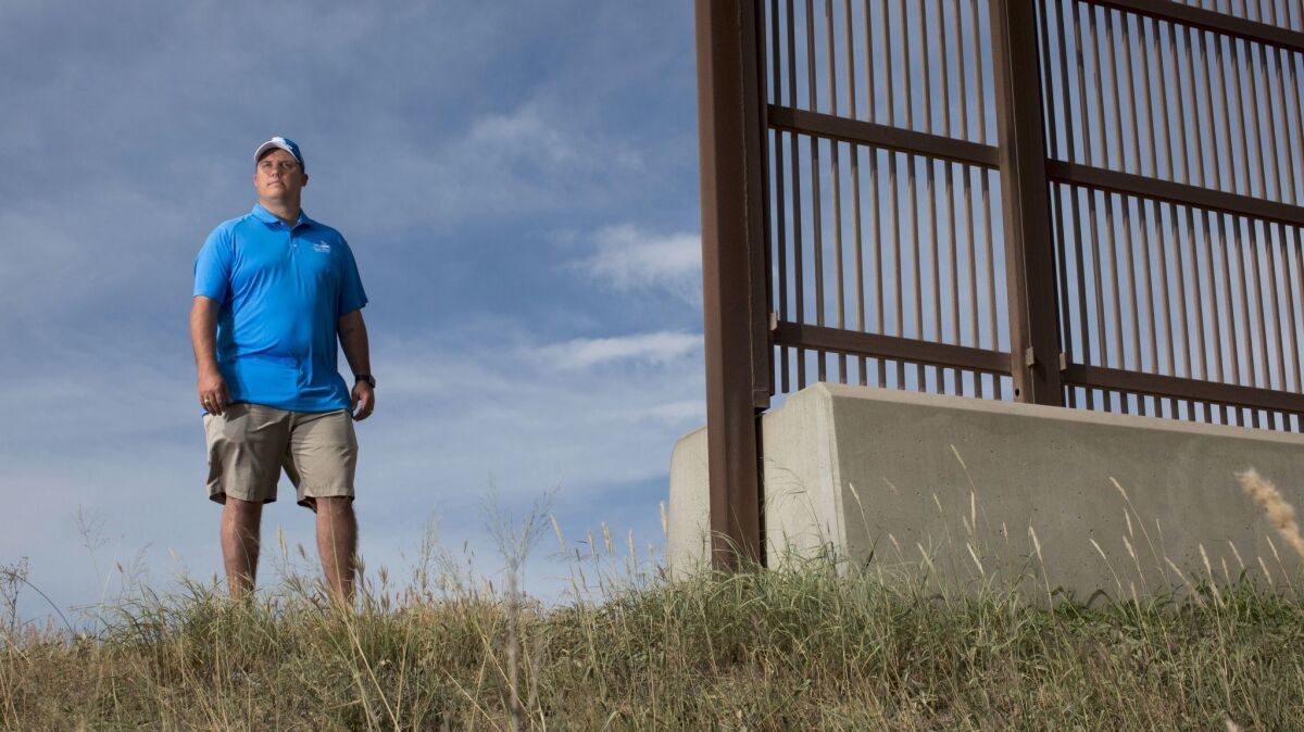 Jeremy Barnard, general manager of River Bend Resort & Golf Club stands at the existing border wall near his property. He has had no contact with the federal government.