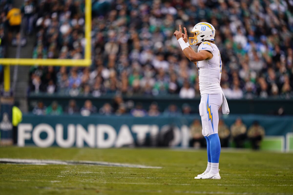 Chargers quarterback Justin Herbert (10) directs the offense against the Eagles.