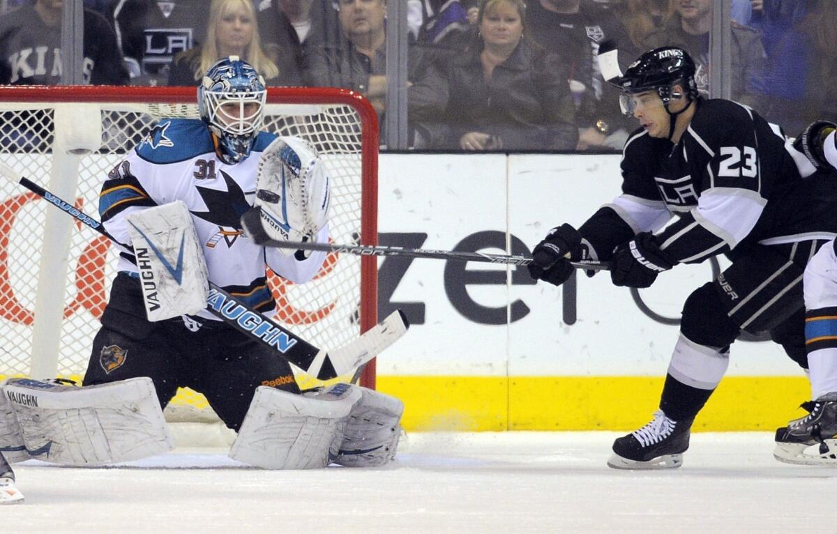 San Jose goalie Antti Niemi, left, makes a stop as Kings right wing Dustin Brown tries to redirect the puck when the two teams met back in April.