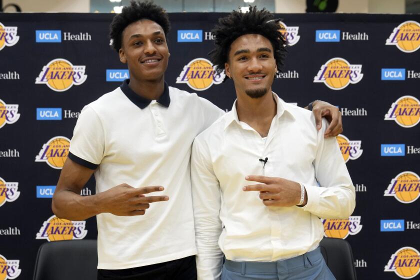Maxwell Lewis, the 40th overall pick, left, and Jalen Hood-Schifino, the 17th overall pick by the Los Angeles Lakers pose for a photo as they are introduced at a news conference at the UCLA Health Training Center in El Segundo, Calif., on Tuesday, June 27, 2023. (AP Photo/Damian Dovarganes)