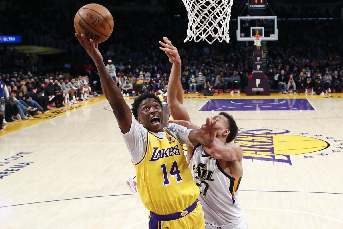 Los Angeles Lakers forward Stanley Johnson (14) goes to basket while defended by Utah Jazz center Rudy Gobert (27).