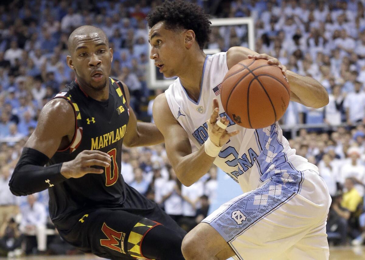 North Carolina guard Marcus Paige (5) dribbles past Maryland's Rasheed Sulaimon (0) during the first half.