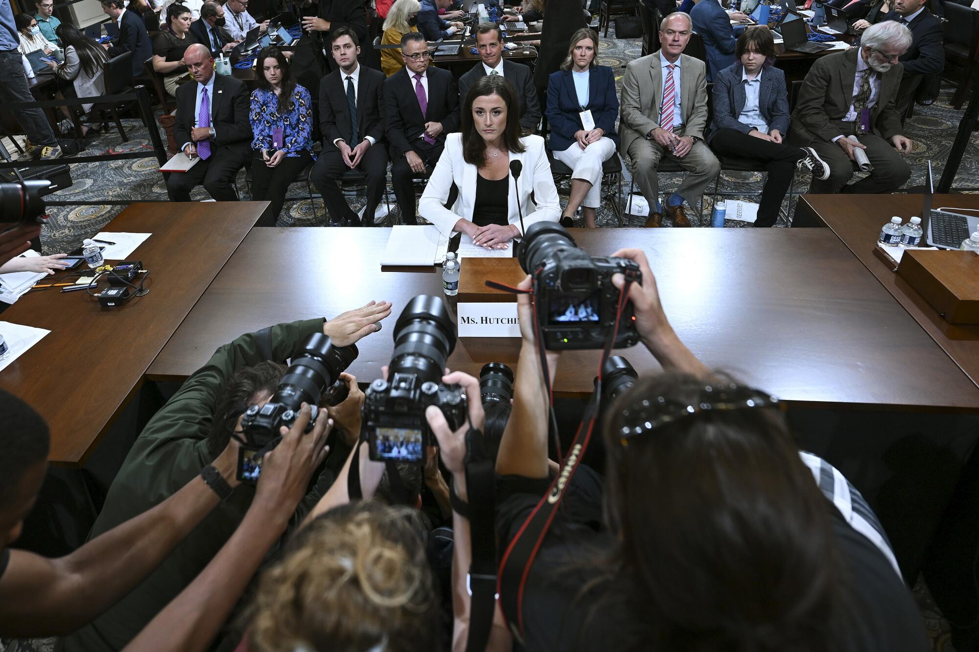 Cassidy Hutchinson, a top former aide to Trump White House Chief of Staff Mark Meadows, takes her seat following a break