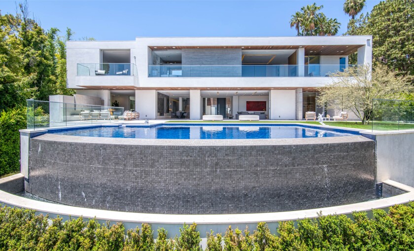 An above-ground pool with a home behind it