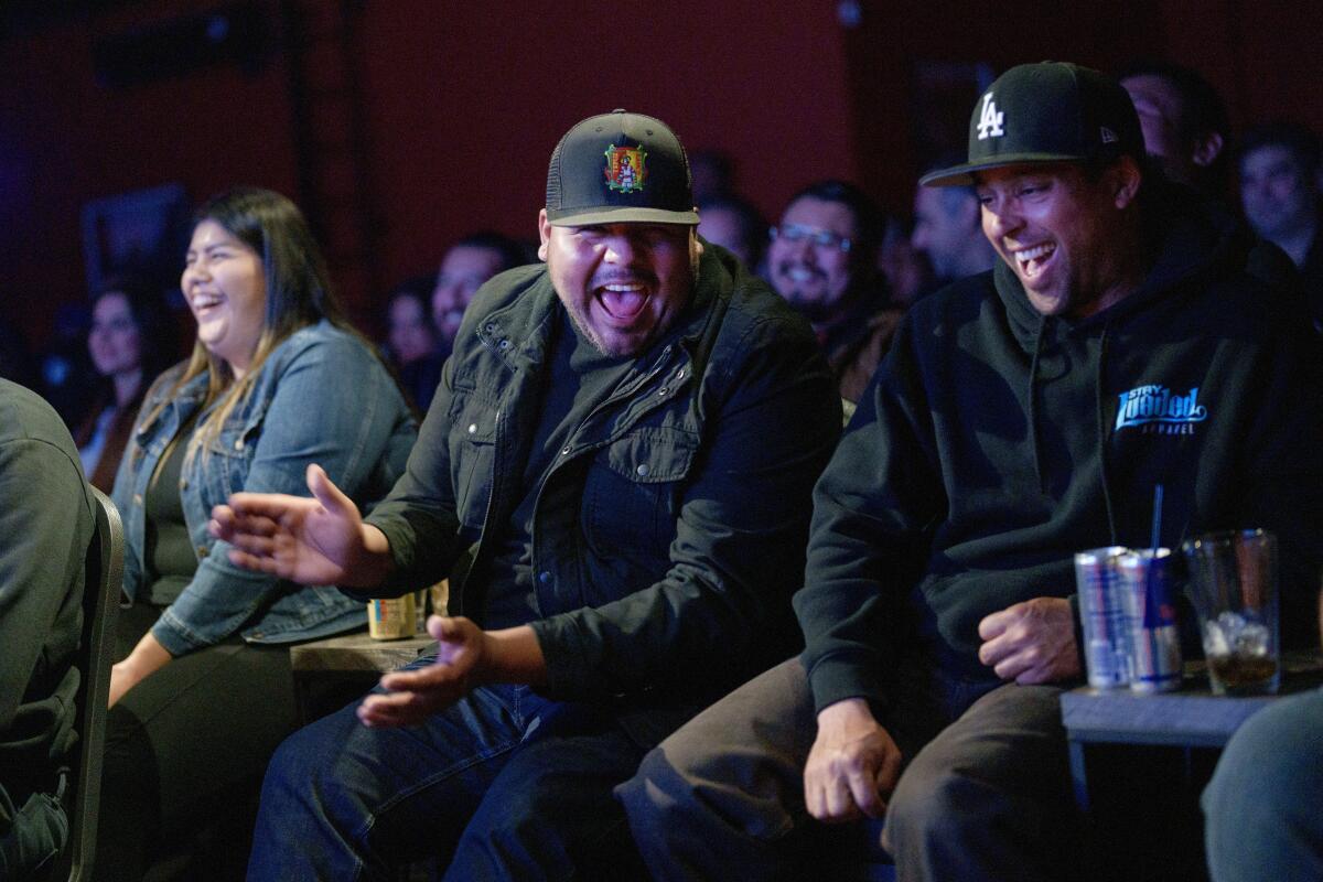Audience members respond astatine the Upstairs Comedy Club .